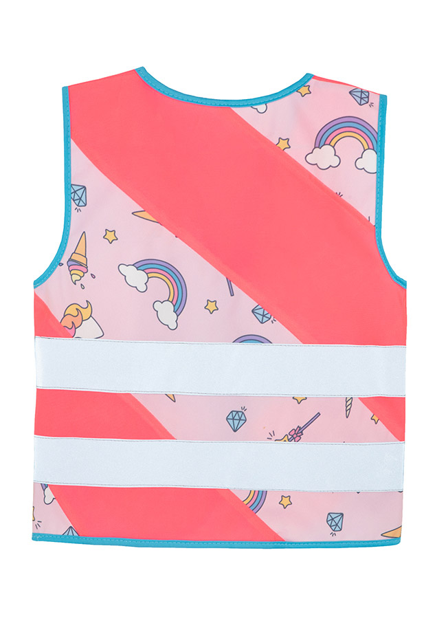 Child in a neon pink Korntex safety vest with a unicorn pattern in front of a children's carousel
