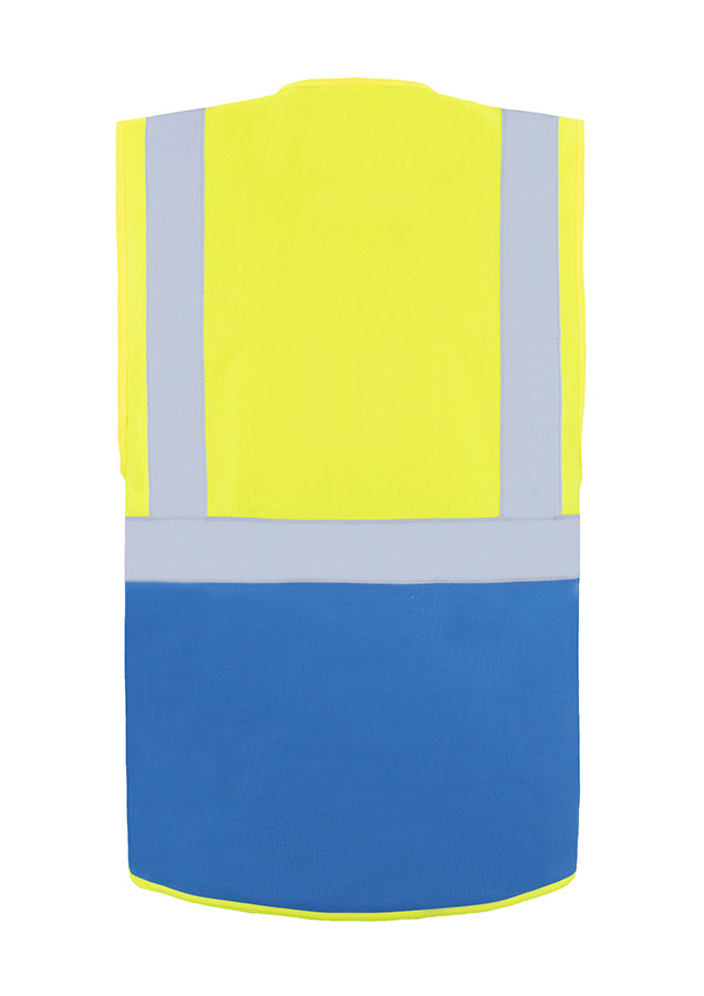 A woman wears a pink Korntex safety vest with reflective stripes in a warehouse