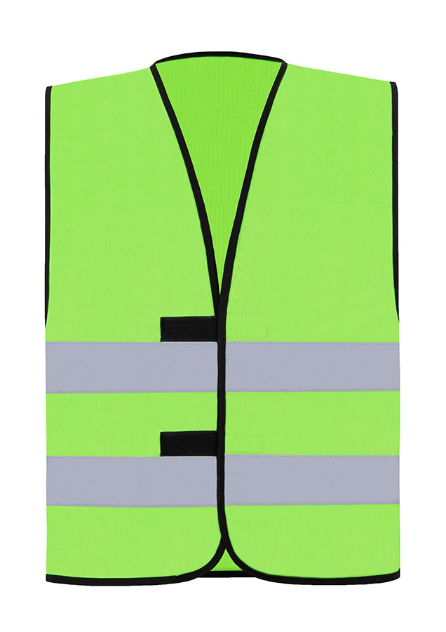 Adult construction worker stands in reflective light green Korntex safety vest and white hard hat on an industrial site