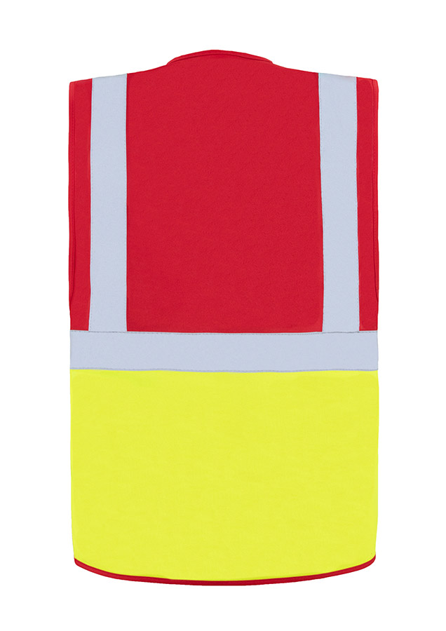 A woman wears a pink Korntex safety vest with reflective stripes in a warehouse