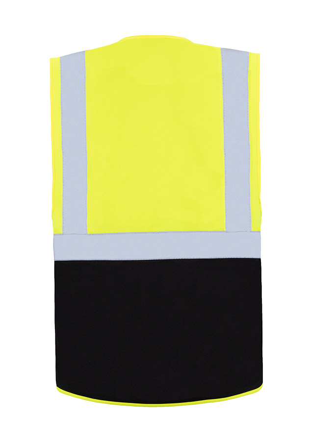 A woman wears a pink Korntex safety vest with reflective stripes in a warehouse