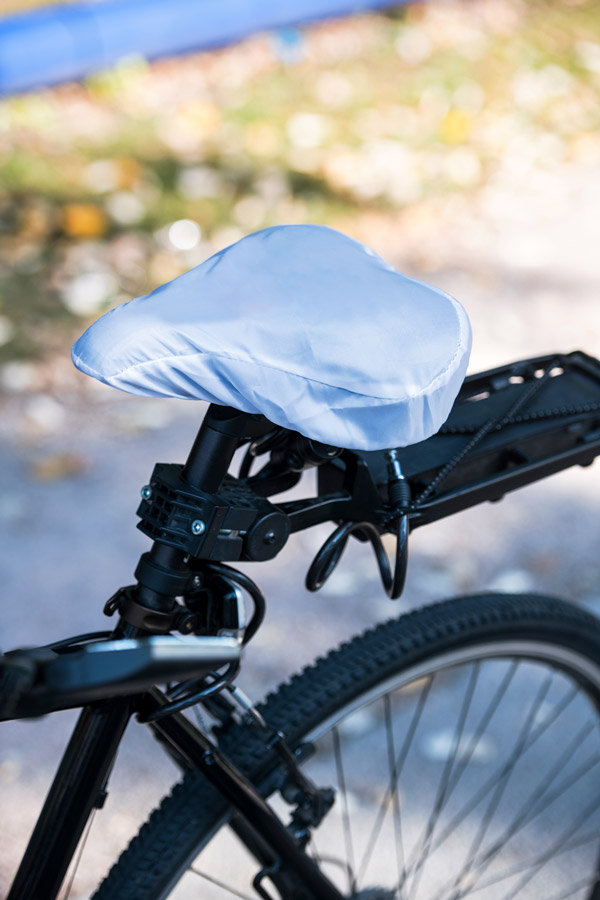Detailed view of a white Korntex bicycle-saddle cover on a mountain bike in the park