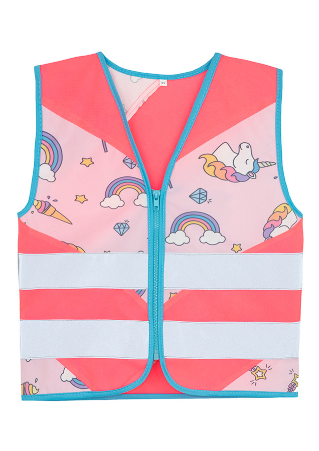 Child in a neon pink Korntex safety vest with a unicorn pattern in front of a children's carousel