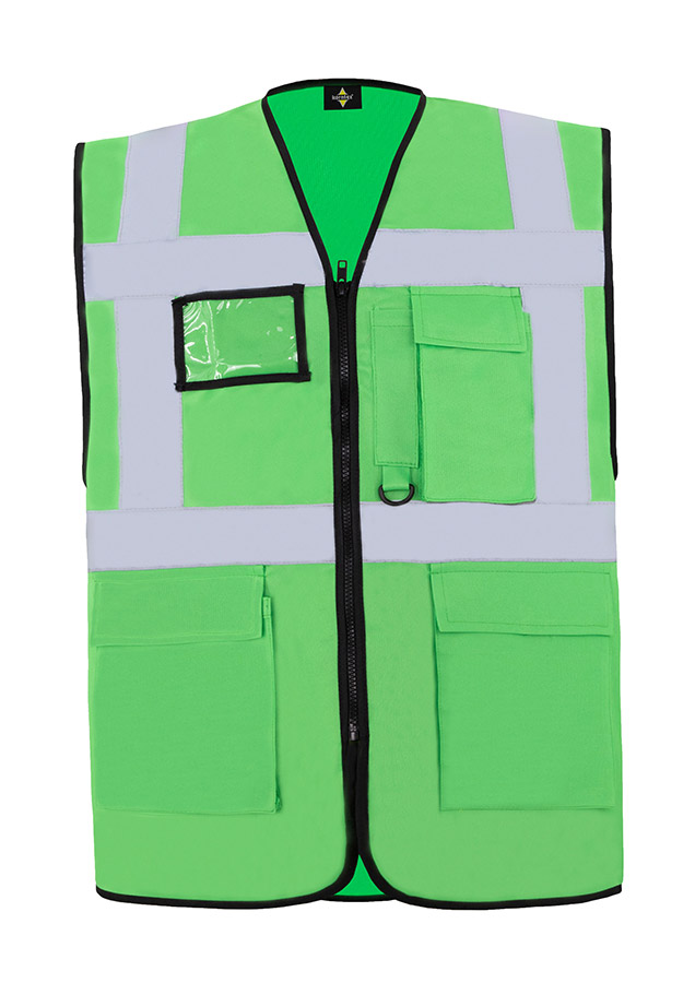 A woman wears a pink Korntex safety vest with reflective stripes in a warehouse