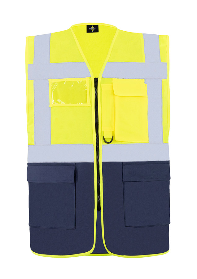 A woman wears a pink Korntex safety vest with reflective stripes in a warehouse