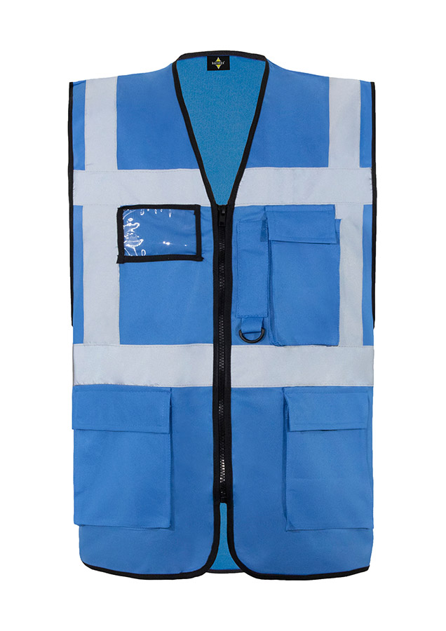 A woman wears a pink Korntex safety vest with reflective stripes in a warehouse