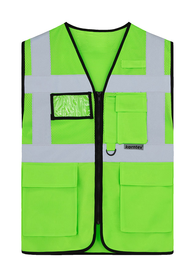 Adult worker with orange Korntex mesh multifunctional safety vest and helmet holding a tool on a railway site in front of a train