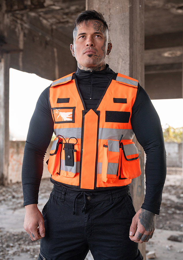 Adult in orange Korntex tactical safety vest with zip on a construction site
