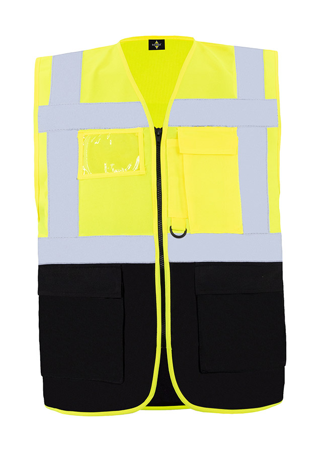 A woman wears a pink Korntex safety vest with reflective stripes in a warehouse