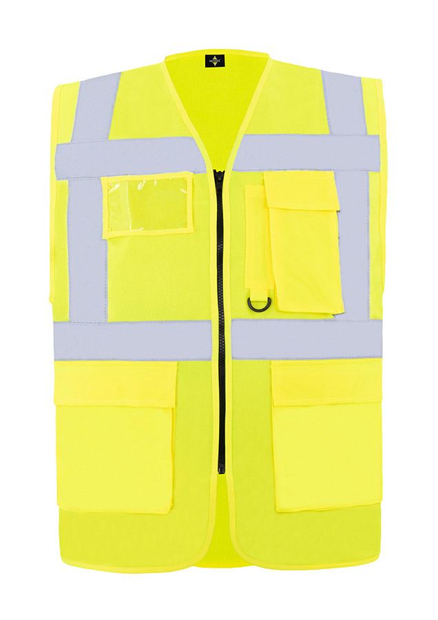 A woman wears a pink Korntex safety vest with reflective stripes in a warehouse