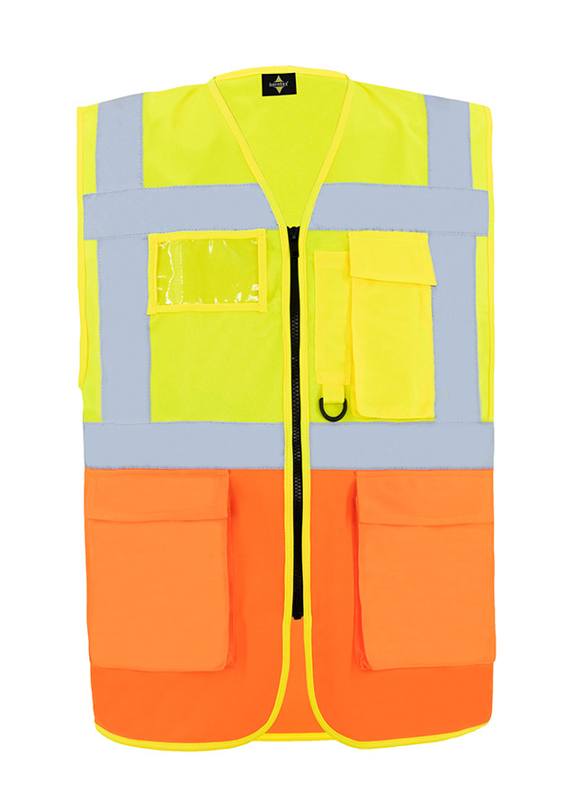 A woman wears a pink Korntex safety vest with reflective stripes in a warehouse