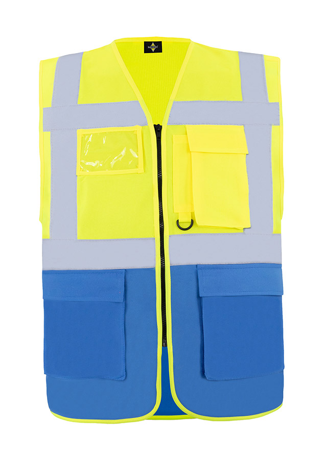 A woman wears a pink Korntex safety vest with reflective stripes in a warehouse