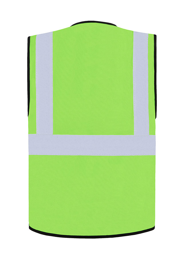 Construction worker in orange Korntex multifunctional safety vest and helmet communicates via radio on a construction site