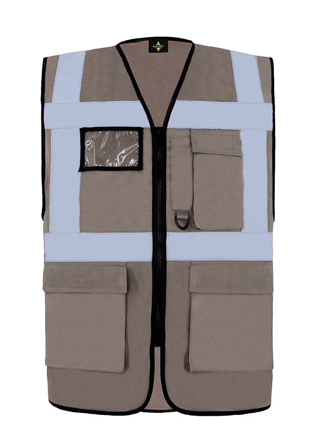 A woman wears a pink Korntex safety vest with reflective stripes in a warehouse