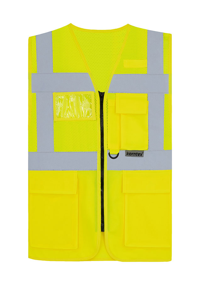 Adult worker with orange Korntex mesh multifunctional safety vest and helmet holding a tool on a railway site in front of a train