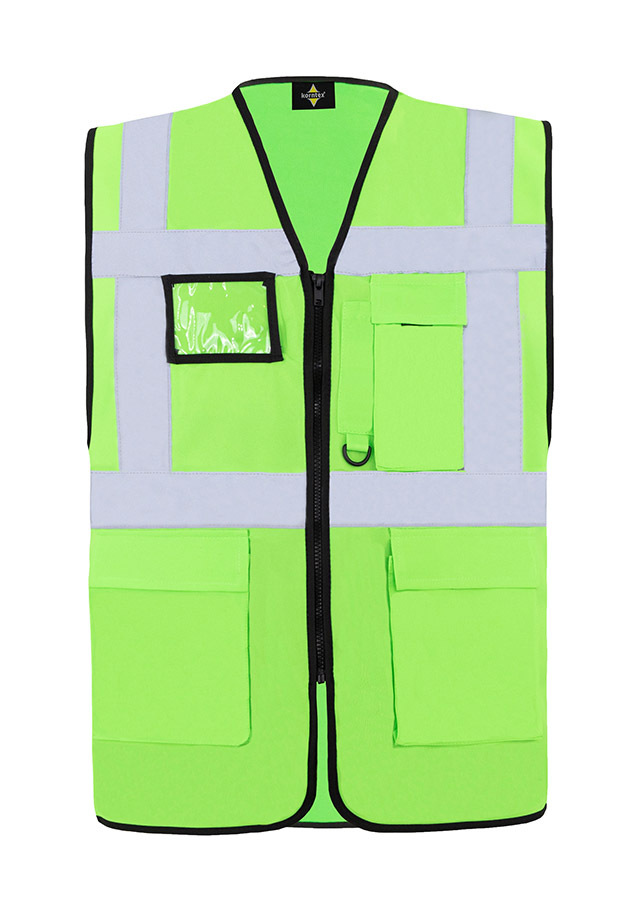 A woman wears a pink Korntex safety vest with reflective stripes in a warehouse