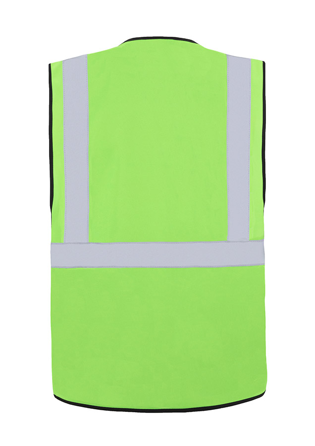 A woman wears a pink Korntex safety vest with reflective stripes in a warehouse