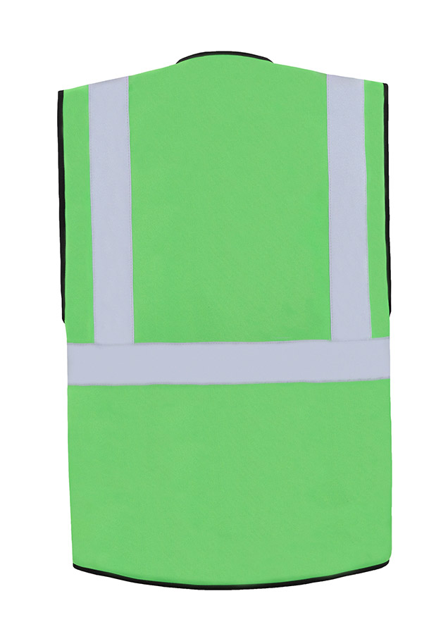 A woman wears a pink Korntex safety vest with reflective stripes in a warehouse