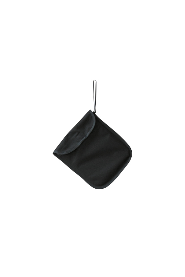 Adult person holding a signal yellow Korntex storage bag