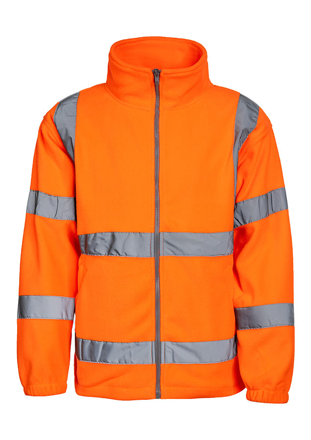 Adult man wearing a signal orange Korntex hi-vis fleece jacket with reflective stripes walking in front of an industrial buil