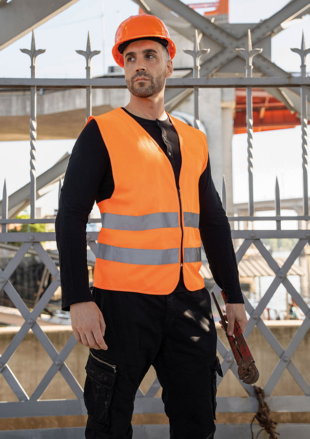 Adult orange Korntex safety vest with zip in an industrial environment