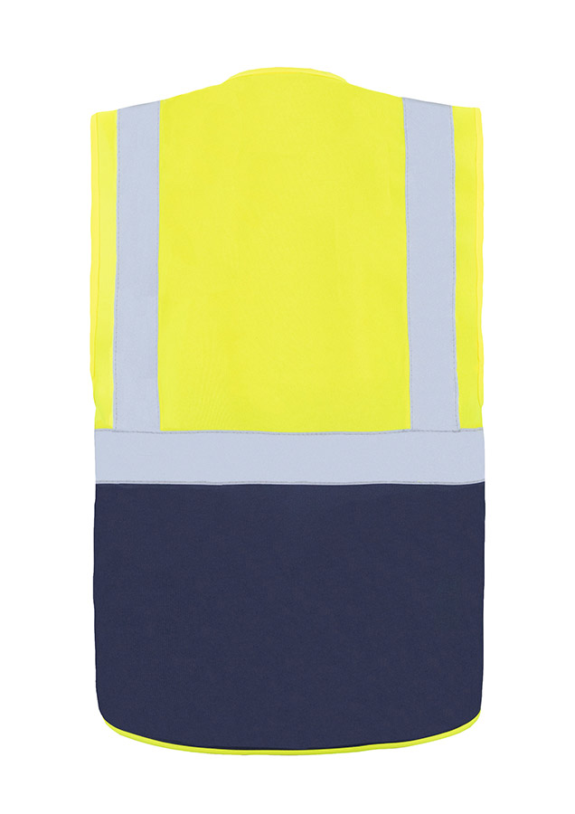 A woman wears a pink Korntex safety vest with reflective stripes in a warehouse