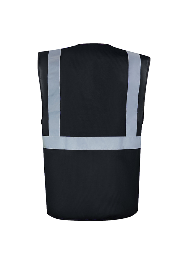 A woman wears a pink Korntex safety vest with reflective stripes in a warehouse