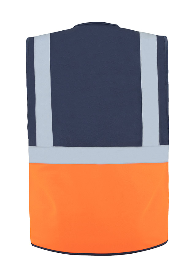 A woman wears a pink Korntex safety vest with reflective stripes in a warehouse