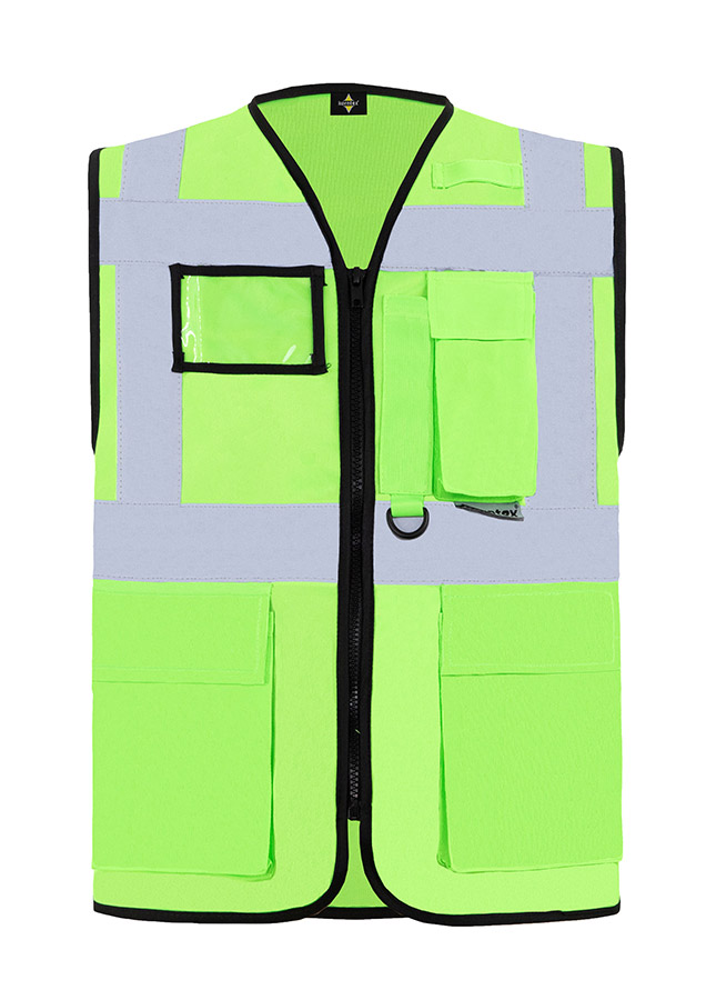 Construction worker in orange Korntex multifunctional safety vest and helmet communicates via radio on a construction site