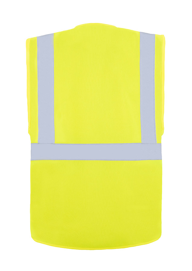 A woman wears a pink Korntex safety vest with reflective stripes in a warehouse
