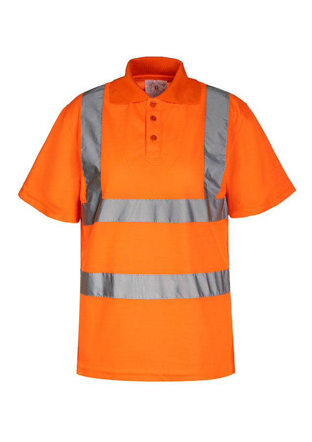 An adult construction worker is standing in front of a demolished building, wearing a fluorescent yellow Korntex polo shirt with a walkie-talkie.