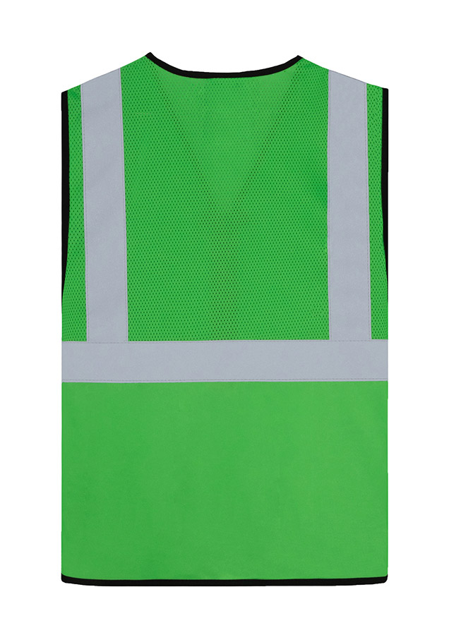 Adult worker with orange Korntex mesh multifunctional safety vest and helmet holding a tool on a railway site in front of a train
