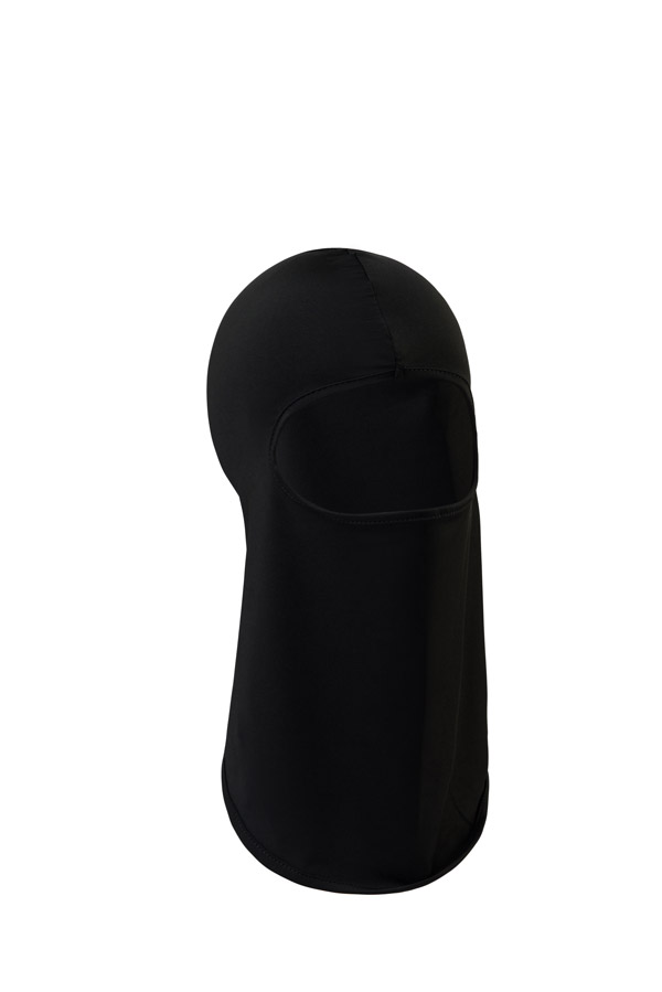 Portrait of an adult man wearing a black Korntex balaclava against a dark background