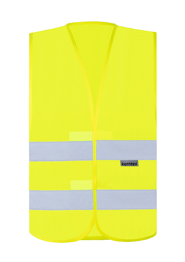 Adult woman in signal yellow Korntex safety vest with reflective stripes holding a radio in an industrial environment