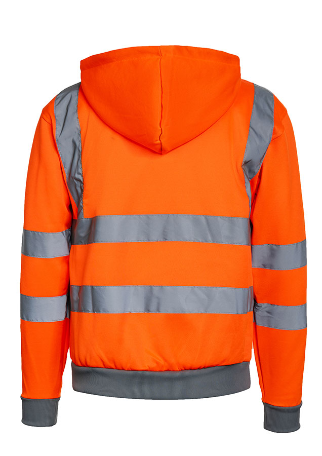 Adult man stands in signal yellow Korntex hi-vis hoodie with reflective stripes and black work trousers in an industrial environment