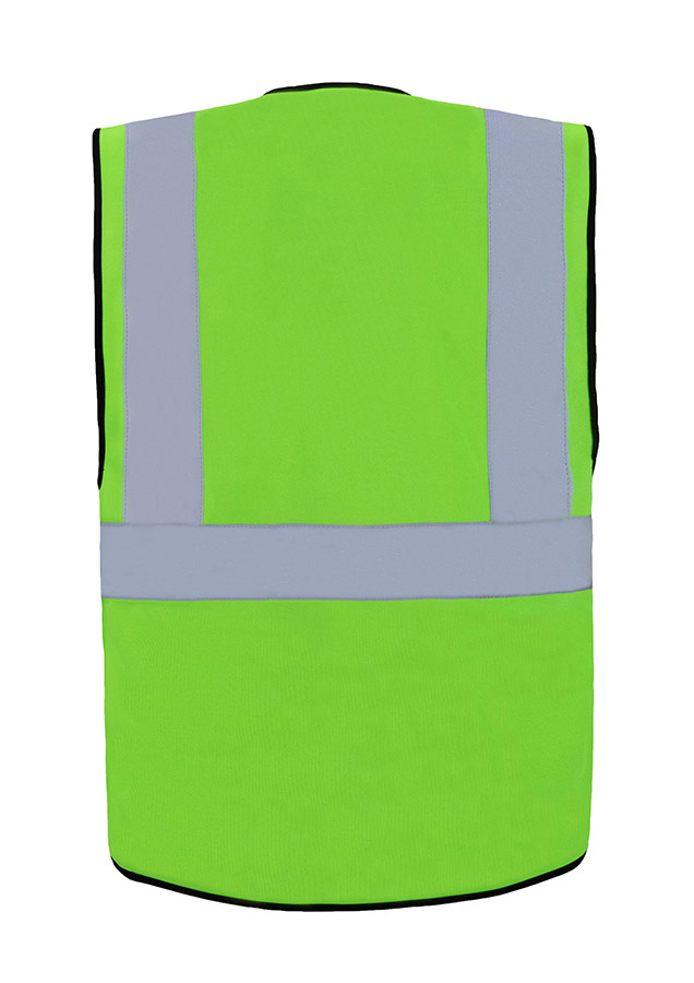 A woman wears a pink Korntex safety vest with reflective stripes in a warehouse