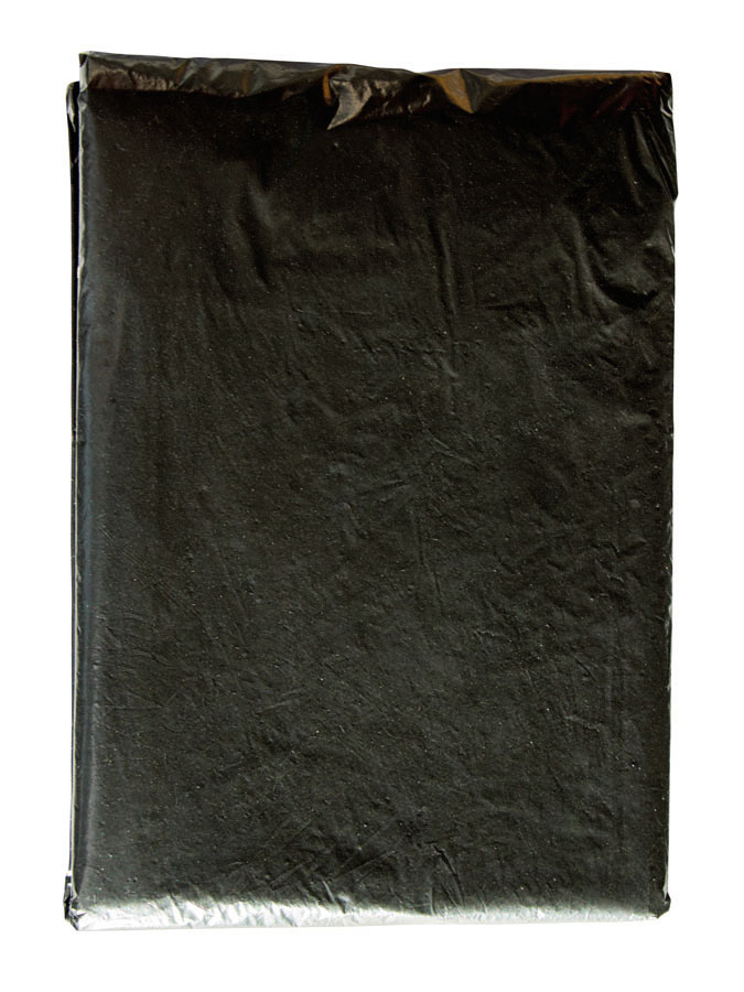 Adult woman wearing a black Korntex disposable raining poncho in a park