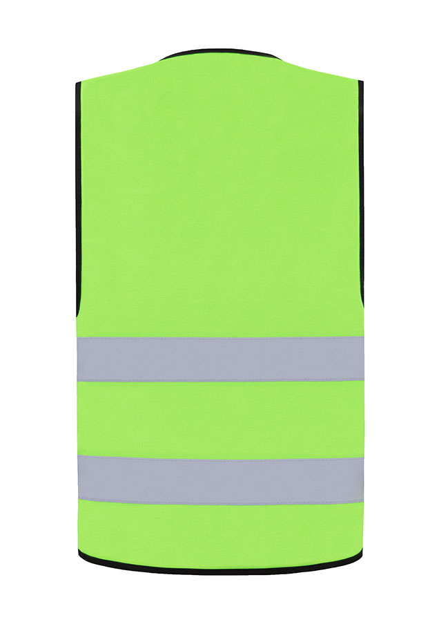 Adult construction worker stands in reflective light green Korntex safety vest and white hard hat on an industrial site