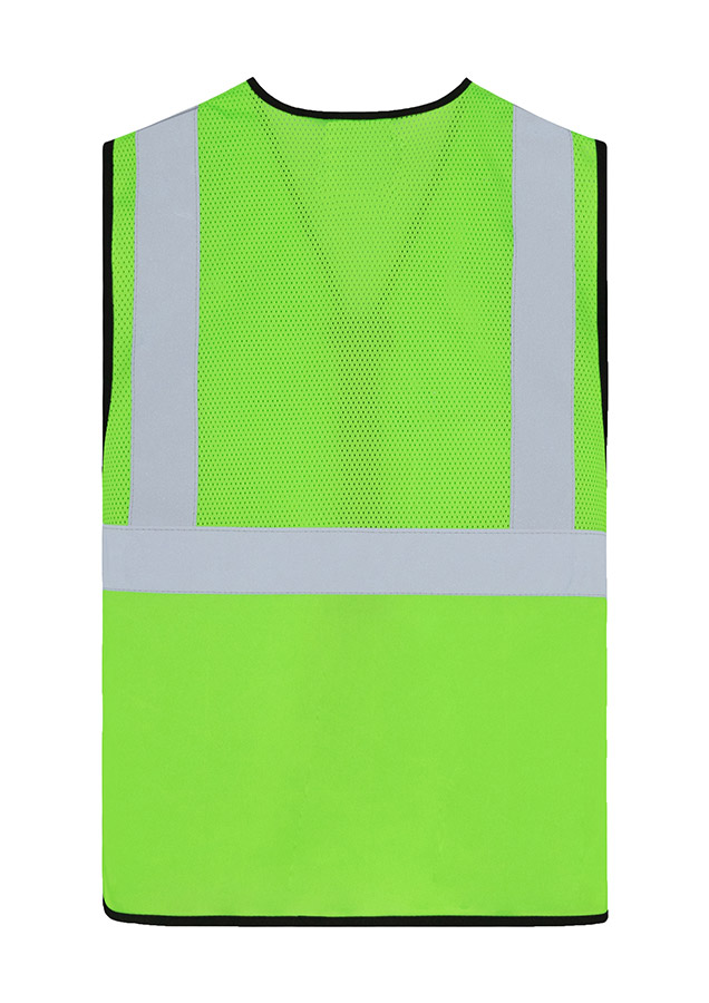 Adult worker with orange Korntex mesh multifunctional safety vest and helmet holding a tool on a railway site in front of a train