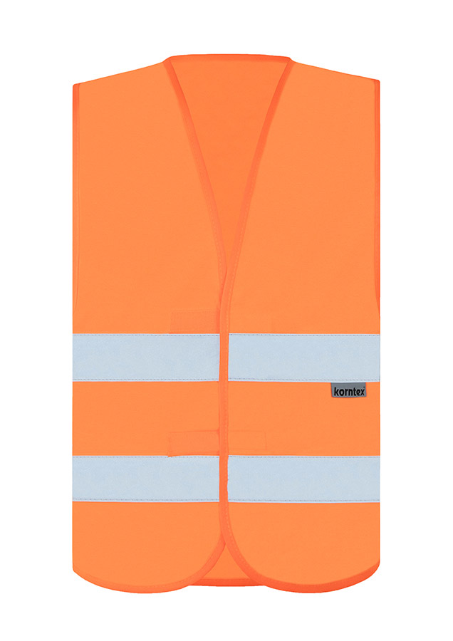 Adult woman in signal yellow Korntex safety vest with reflective stripes holding a radio in an industrial environment
