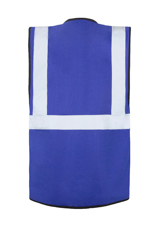 A woman wears a pink Korntex safety vest with reflective stripes in a warehouse