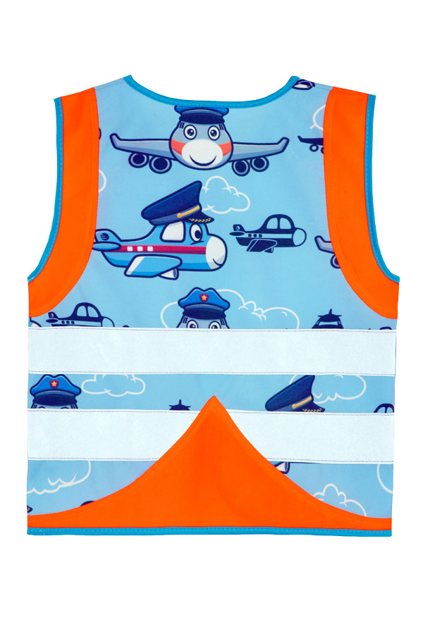 Child in an orange Korntex safety vest with an aeroplane pattern in a playground