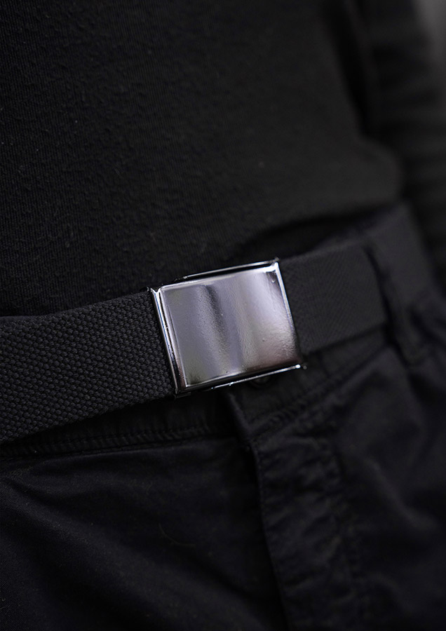 Close-up of a black Korntex polyester belt with metal buckle