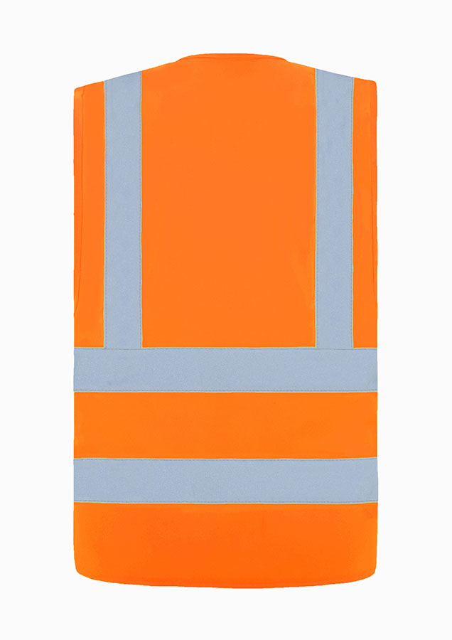 Adult man in fluorescent signal yellow Korntex safety vest standing in front of large metal containers